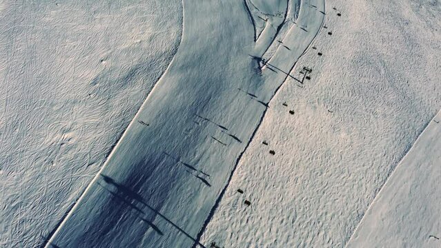 Above chairlift and downhill ski slope in Austria, aerial