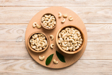 cashew nuts in wooden bowl on table background. top view. Space for text Healthy food