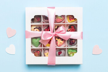 Valentine day composition: sweet candy, with gift boxes with bow and red felt hearts, photo...