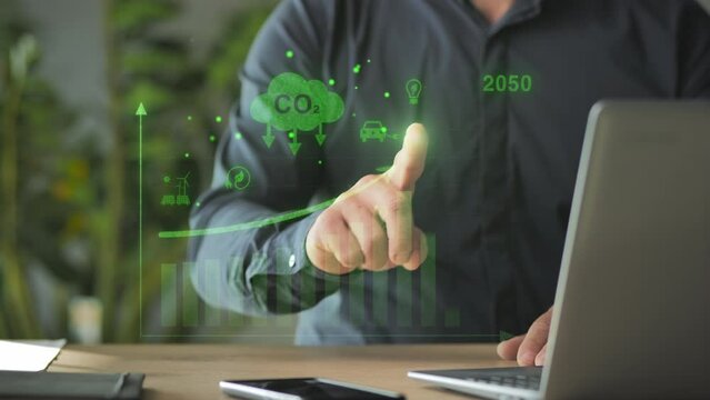 green energy zero emission carbon co2 reduction graph charts,business man at laptop computer using virtual touch screen to show alternative energy growth
