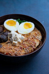 Ramen served in a bowl with egg, tofu, chicken breast, mushroom, sapporo, donkocheu, soup ramen, single serving, fine dining, Japanese cuisine, chives, food photography, restaurant menu
