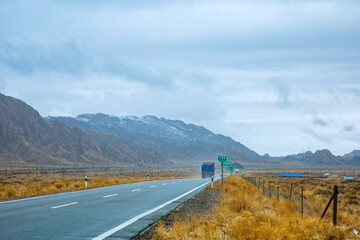Hainan Mongolian and Tibetan Autonomous Prefecture, Qinghai Province-Grasslands and roads under the snow-capped mountains