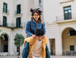 woman couple man happy hugging love young together piggyback travel tourist romantic hugging...