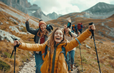 Happy group of friends hiking and smiling while holding walking sticks on mountain path - Powered by Adobe