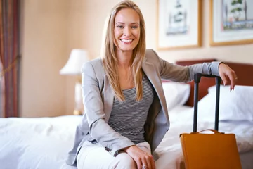 Foto op Canvas Hotel, travel and portrait of business woman for work trip, global conference and meeting. Accommodation, professional worker and happy person with suitcase in bedroom for career, working and job © ArcursJointTeam/peopleimages.com