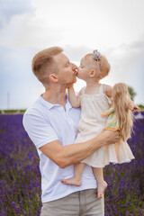 the daughter kisses her father. family picnic on a lavender field