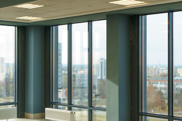 Panoramic windows in an empty spacious room. Installation of fiberglass windows in the business...