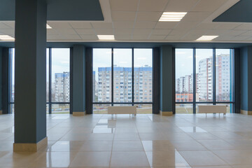 Panoramic windows in an empty spacious room. Installation of fiberglass windows in the business...