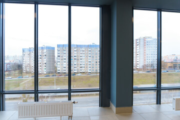 Panoramic windows in an empty spacious room. Installation of fiberglass windows in the business center.