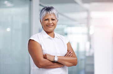 Business woman, senior and smile with arms crossed in portrait at office, confidence and pride in career. Boss, executive or CEO of sales company, happy expert or entrepreneur with ambition and power