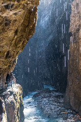 cave in the mountains with waterfall in the sunny morning in Bayern