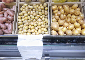 various types of potatoes on a market counter