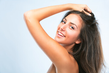 Obraz premium Woman, portrait and happy in studio with hair care for soft texture, cosmetics and salon glow with collagen treatment. Model, person and natural beauty with skincare and grooming on white background