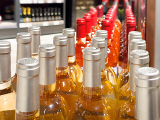 defocused alcohol (wine, champagne, liquor, whiskey) on store shelves