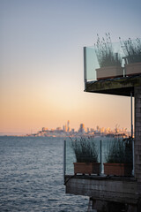In the background, the skyline of the city of San Francisco rises up over the water of the San...