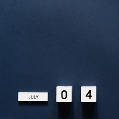 4th of July wooden calendar with date on blue background. American Independence Day.