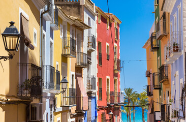 Fototapeta na wymiar Colorful facades in a steep street in Villajoyosa, Spain