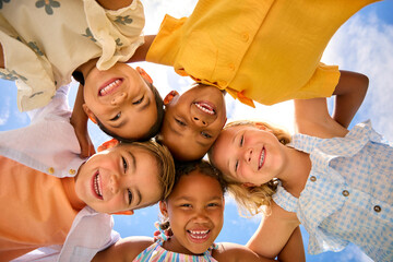 Group Of Multi-Cultural Children Friends Linking Arms Looking Down Into Camera - 763110845