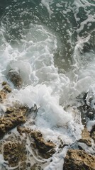 Foaming sea waves hitting rocks