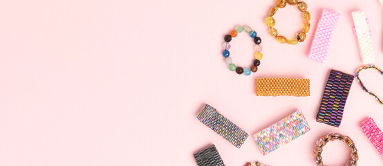 Banner with handmade beaded rings on a pink background. Place for text.