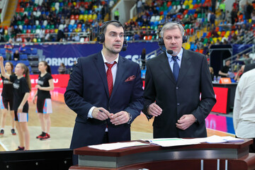 two Commentators at basketball game in stadium