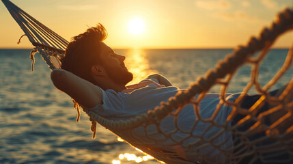Young man lying in a hammock by the ocean and sunset view. A handsome guy is resting in a hammock against the backdrop of the mountains by the sea. - Powered by Adobe