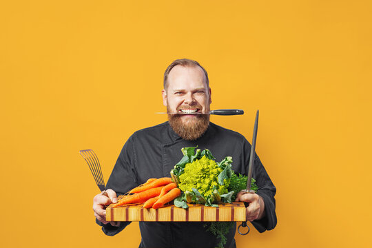 A positive chef ready for vegetarian cooking.