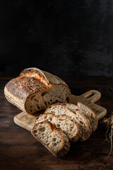 Homemade sourdough bread. Fresh Sourdough bread cut in half, on a black background.