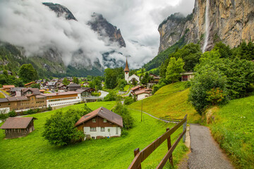 Lauterbrunnen village in Swiss Alps, calm foggy weather - 763120684