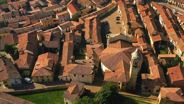 Aerial tilt shot rotating over the Church and the Montemagno town, in sunny Italy
