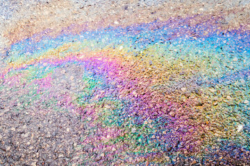 Leaked Gasoline Oil Slick or Petrol Rainbow Enviromental leak On Tarmac Road