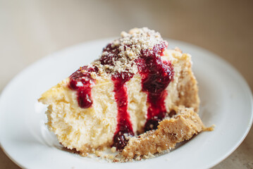 Delicious dessert - homemade cheesecake with berry sauce