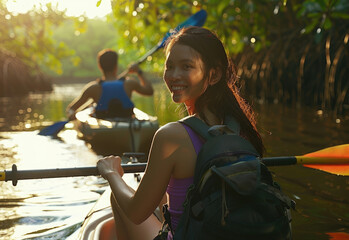 mixed race couple kayaking in the mangroves at sunrise