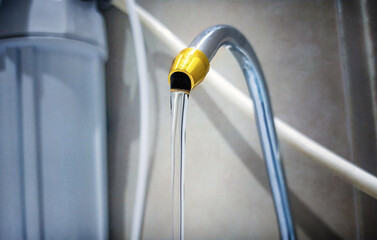 Clean water flows from a filtration tap, ensuring purity and safety.