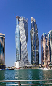 Dubai, United Arab Emirates &ndash; March 6, 2024: Dubai Marina skyscrapers with popular twisted Cayan Tower, view from the Marina Walk &ndash; famous walking promenade. Dubai skyline