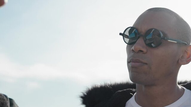 Portrait of African American trendy bald man with eyeglasses