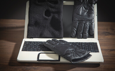 Mask, gloves and laptop computer on the table.