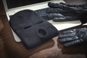 Mask, gloves and laptop computer on the table.