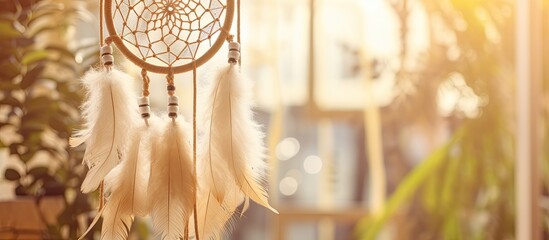 A dream catcher hangs from a wooden window sleeve in a room, surrounded by sports equipment,...