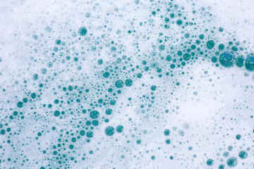 Detergent foam bubble on water. Blue background, Soap sud
