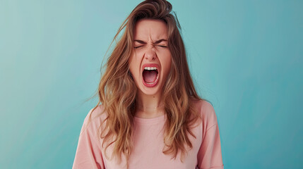 The young emotional angry woman screaming on pastel blue background - obrazy, fototapety, plakaty