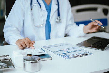 Doctor use a service fee calculator to save money on health insurance, drug cost concept.