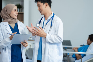 Medical professionals discussion something on clipboard close up. Ward round, patient visit check, medical calculation and statistics concept.