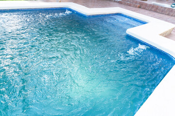 A stream of sprayed water fills the pool with clean water and filters it. Pool cleaning process....