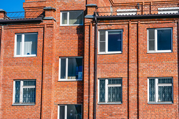 A fragment of the brick facade of the building on a spring day