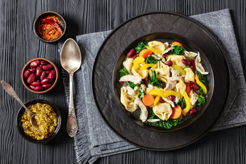 chicken minestrone soup with tortelloni in bowl