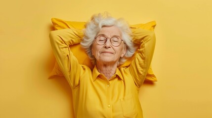 Elderly woman sleeping on pillow isolated on pastel yellow colored background Sleep deeply peacefully rest. Top above high angle view photo portrait of satisfied .senior wear yellow shirt - obrazy, fototapety, plakaty