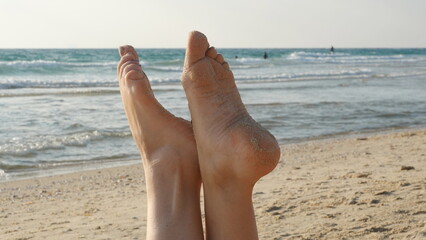 Sandy Feet Against Seashore Backdrop, Relaxation Concept With Ocean View And Sandy Beach