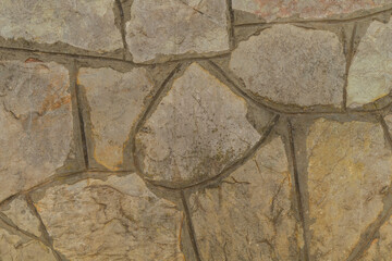 Background with stone cladding in the form of natural stone masonry. The style of ancient palaces...