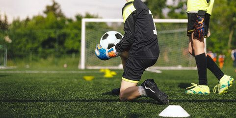 Boys on Goalkeepers Training. Young Soccer Goalies Catching Ball on Practice Drill. Players on the...